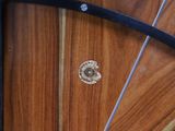a close up of a wooden surfboard with a metal handle