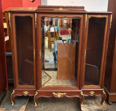 a wooden cabinet with a mirror on top of it