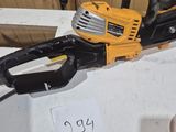 a chainsaw sitting on top of a table next to a sign