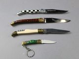 several different types of knives are lined up on a table