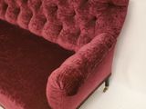 an image of a red couch sitting on top of a white floor