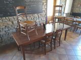 tables and chairs in a room with a chalkboard on the wall