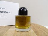 a bottle of perfume sitting on a table next to a box