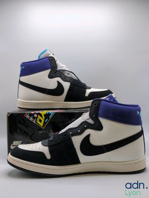 a pair of black and white sneakers with blue accents