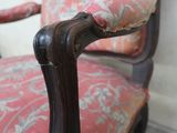 a close up of a chair with a red and white upholstered seat