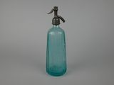an old blue glass bottle with a metal spout on a gray background