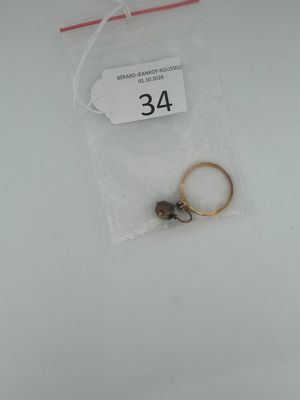 a ring and a pair of gold rings in a bag