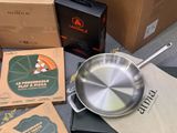 a pan sitting on a table next to a box of pizza