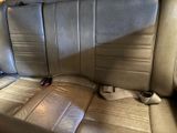 a seat in the back of a car with a remote control on it