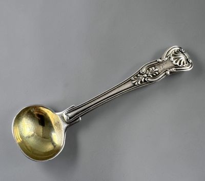 a close up of a spoon with a handle on a table