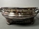 an antique silver plated bowl with handles and handles on a stand