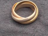a gold ring sitting on top of a gray cloth