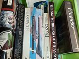 many books in a green box on a table