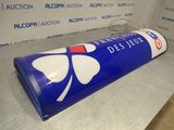 a blue tube with a four leaf clover on it sitting on a counter