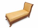 a wooden chaise with a yellow cushion on it