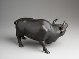 an image of a bronze statue of a bull on a white background