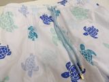 a close up of a blue and white swimsuit with turtles on it