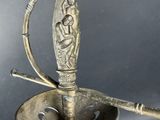 someone is holding a silver plate with a knife in it