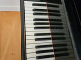 a piano that is sitting in the corner of a room