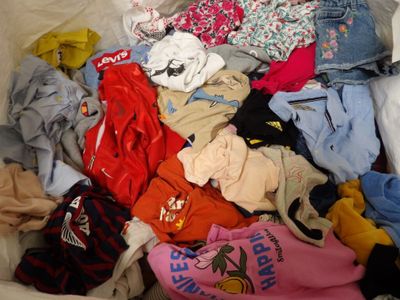 a large pile of clothes that is in a bin