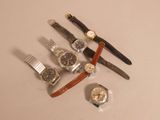 a lot of watches that are sitting on a table