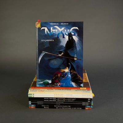 books stacked on top of each other on a gray surface