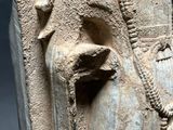 an ancient statue of a woman holding a bird in her hand
