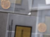 a glass display case with coins on it in a museum