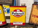 several old oil cans are stacked on top of each other