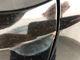a close up of a person ' s reflection on a car door