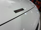 a sticker on the hood of a white car