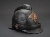 an old helmet with an eagle on the side of it on a black background
