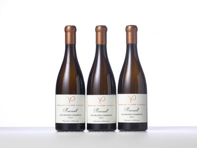 three bottles of wine are lined up on a table