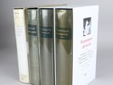 three books are stacked on top of each other on a table