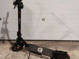a scooter sitting in front of a garage door