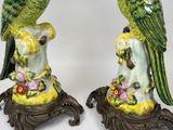 two figurines of parrots sitting on top of each other