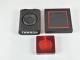 a close up of a camera with a red lens and a black box