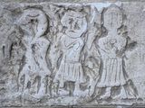 an image of a stone relief with a group of people on it