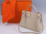 an orange and white box with a grey bag and a orange scarf