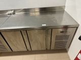 a stainless steel counter in a public restroom