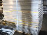 several stacks of steel bars stacked on top of each other in a warehouse