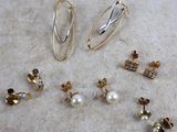 many different types of earrings on the table