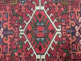 a close up of a red rug with a pattern on it
