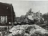an old black and white photo of a pile of rubble in front of a building