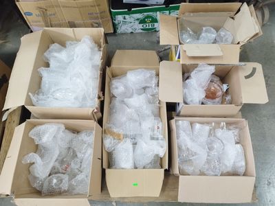 several boxes of assorted items sitting on the floor in a room