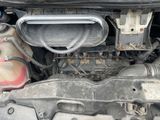 a close up of a car ' s engine with its hood open