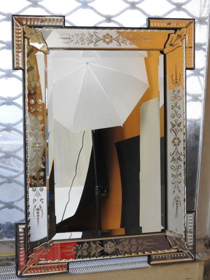 a mirror with a white umbrella in front of it