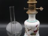 a white and blue vase and a glass on a table