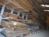 many stacks of wood in a warehouse with a price tag on them