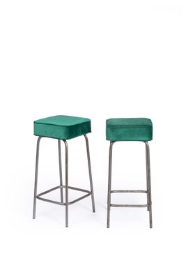 a pair of green velvet stools on a white background